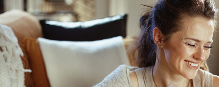 A colorful display of avocado, whole grains, nuts, seeds, avocado, chocolate, and oily fish on a wooden board, showcasing nutrient-rich foods for hormonal balance.