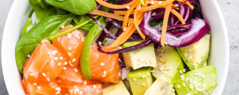 Homemade poke bowl with sushi rice, salmon or tofu, avocado, cucumber and edamame